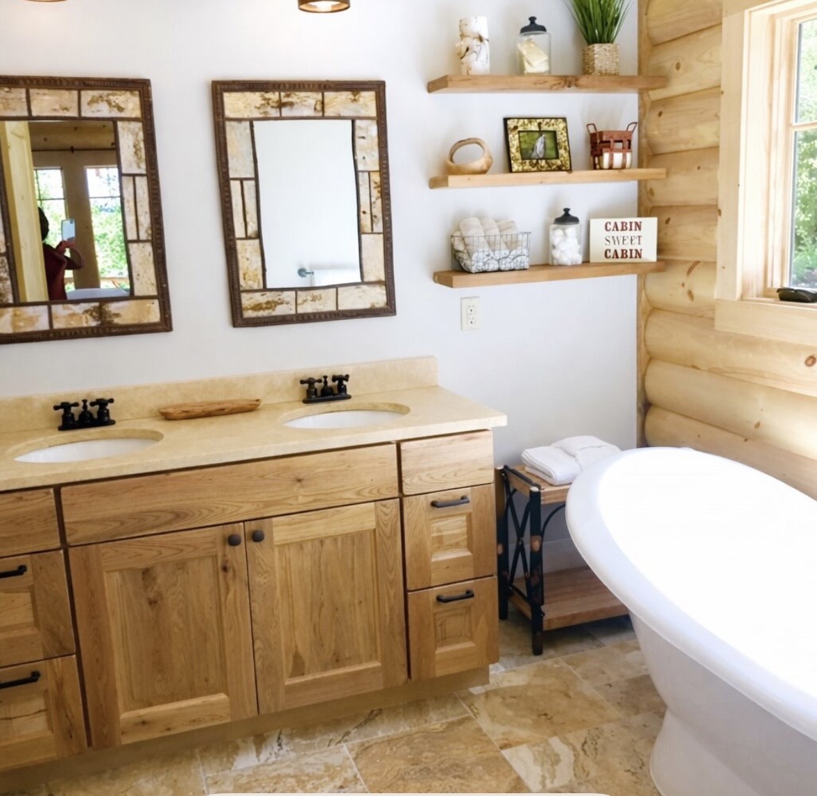 Bathroom with double vanity, open shelving, and soaking tub