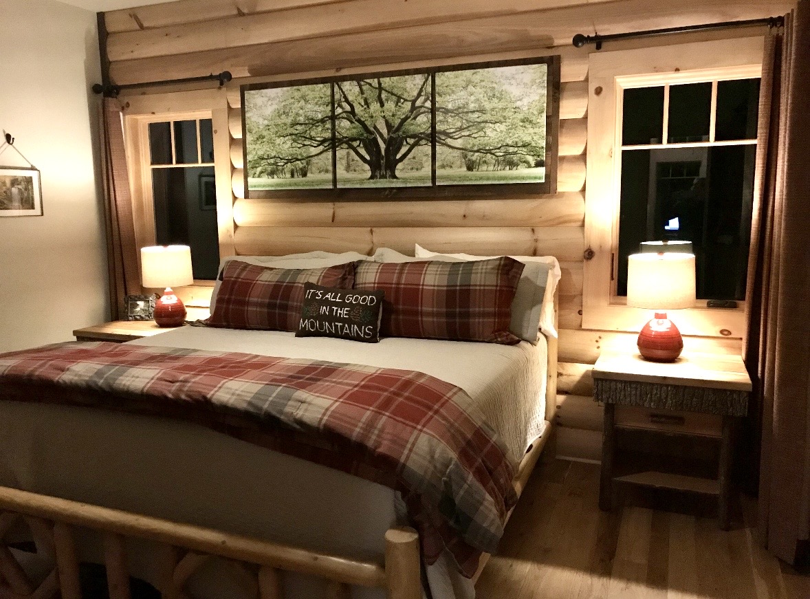 King bedroom with plaid bedding lit at night