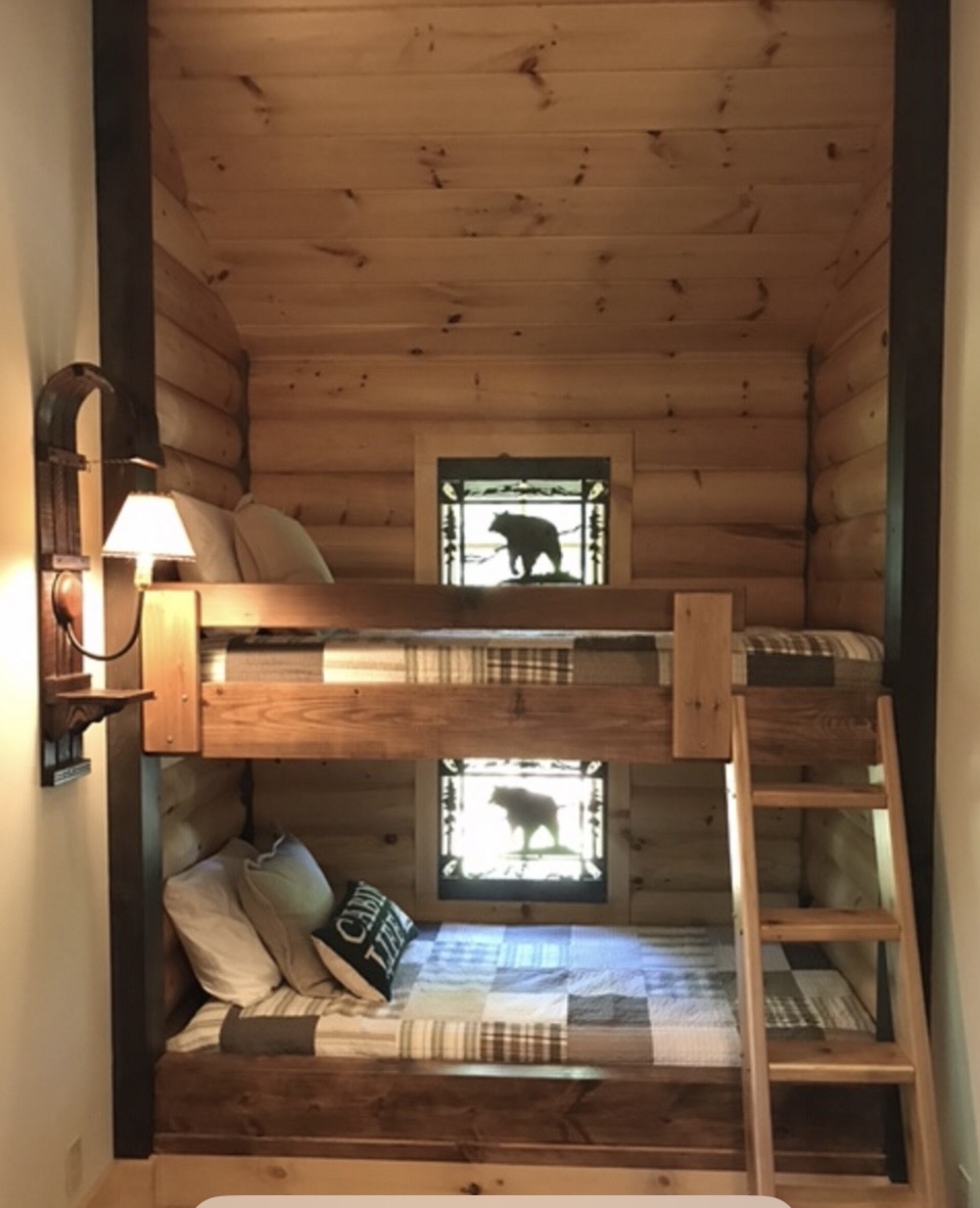 Built-in log bunk beds with bear stained-glass windows