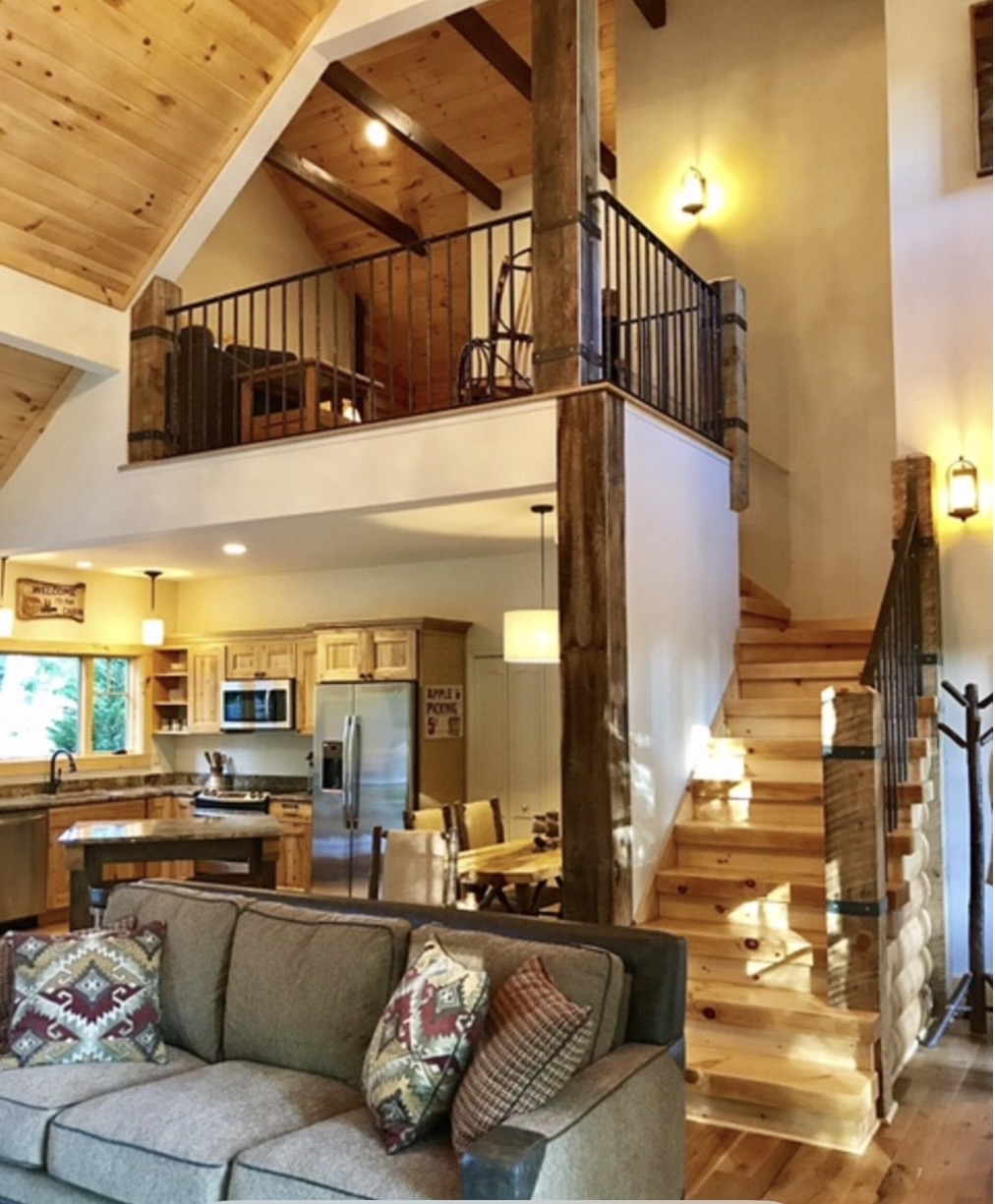 Great room with loft overlook, staircase, and kitchen below