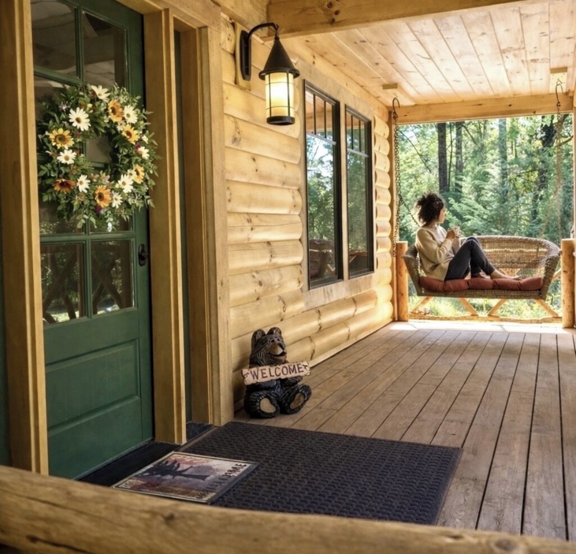 Front porch swing beside the green entry door