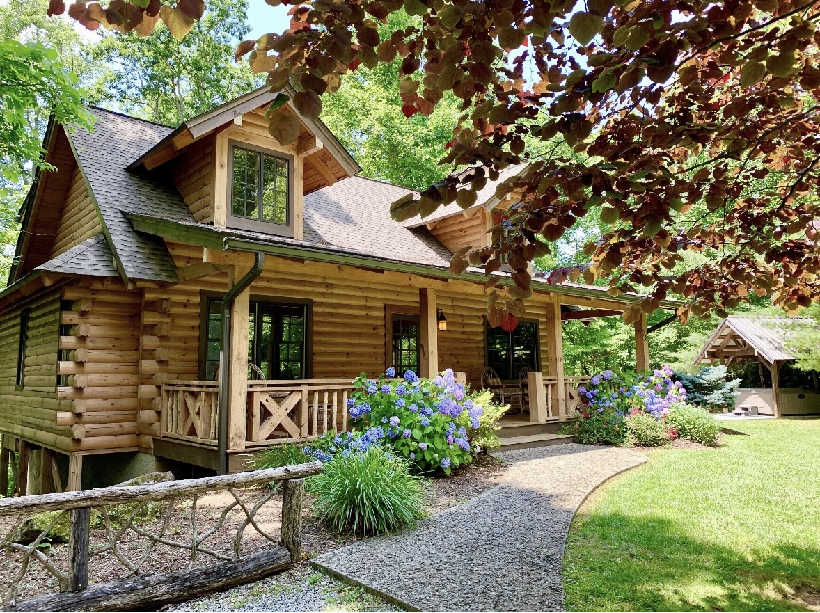 Whispering Pine cabin exterior with hydrangeas along the front walk