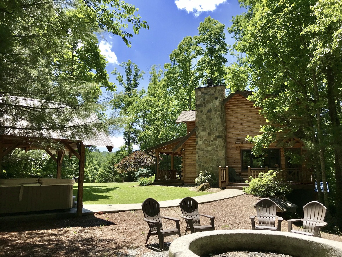 Covered hot tub and fire pit at Whispering Pine