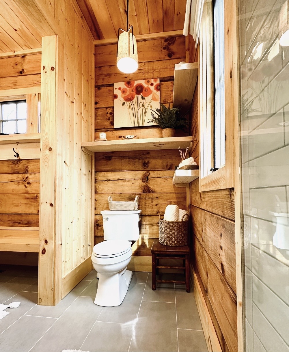 Bathroom nook with floral art and woven shelving