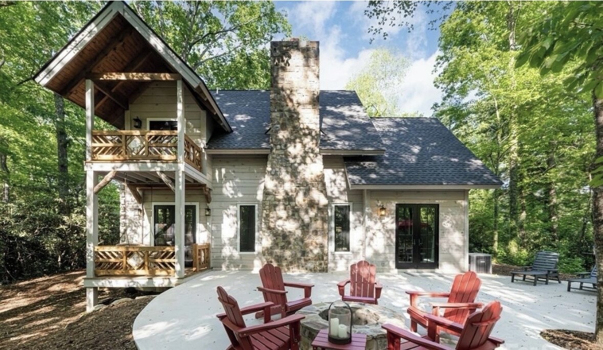 White Oak rear exterior with stone chimney and fire pit patio