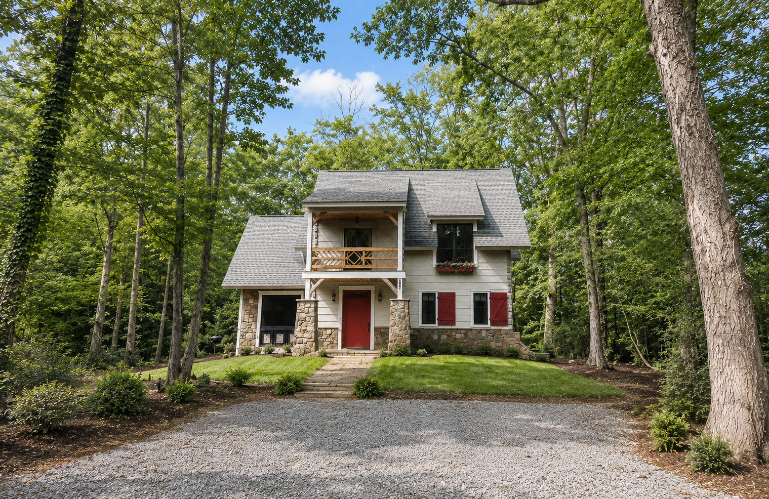 White Oak cabin front exterior with red door and stone base