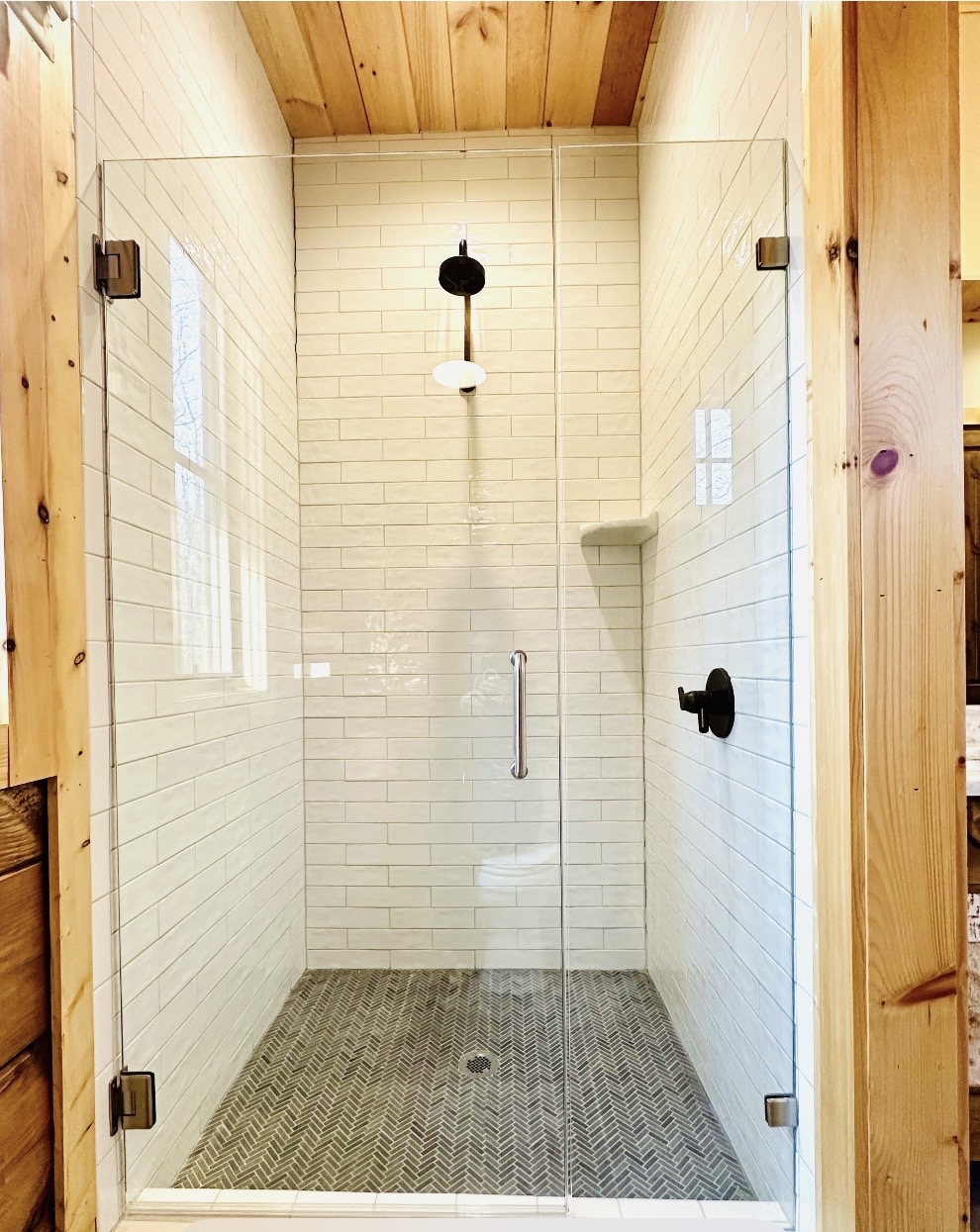 Glass-enclosed subway tile shower